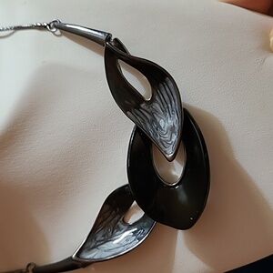 2/$12 Hematite coloured abstract necklace with black and gray enamel design